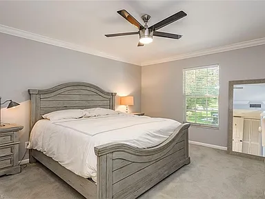 Bedroom with a gray bed frame and bedside lamps