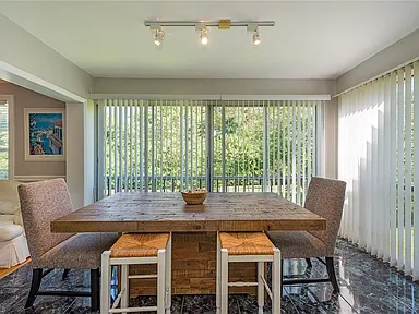 Dining area with a wood table and windows