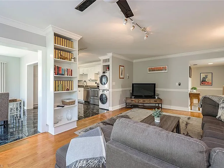 Living room with seating, a window, and built-in shelving